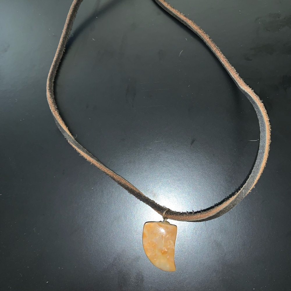 Leather necklace with stone tooth
